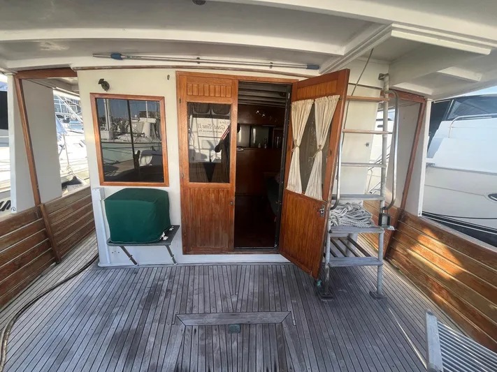 Anna Marie Yacht Photos Pics 1987 Kadey-Krogen 42 yacht deck with wooden doors and seating area.