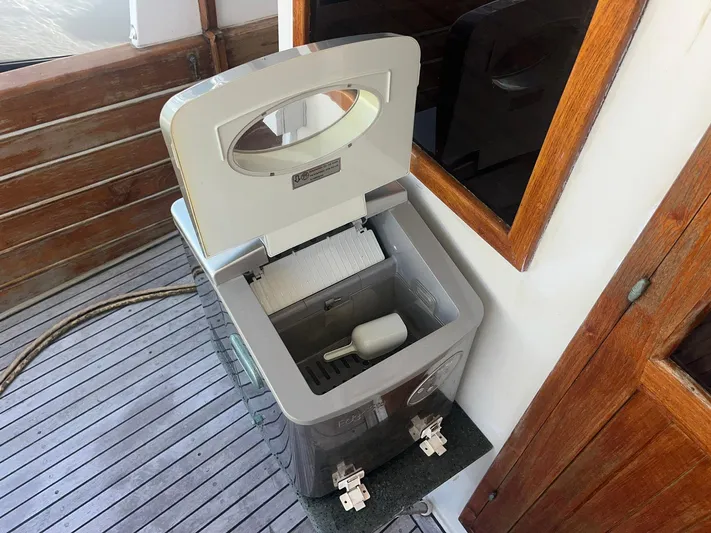 Anna Marie Yacht Photos Pics Ice maker on 1987 Kadey-Krogen 42 boat deck, open lid, wooden surroundings.