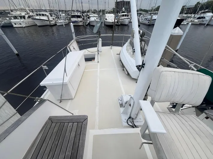 Anna Marie Yacht Photos Pics Deck view of 1987 Kadey-Krogen 42 yacht in marina, featuring seating and storage.