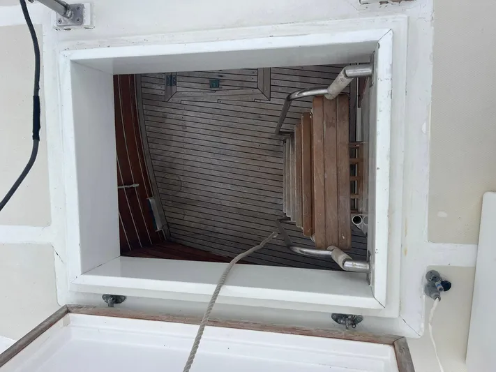 Anna Marie Yacht Photos Pics Hatch opening on 1987 Kadey-Krogen 42 boat, revealing wooden interior stairs.
