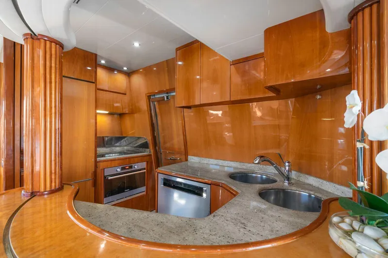  Yacht Photos Pics Luxurious kitchen interior of 2001 Azimut Sea Jet yacht with wooden cabinetry and modern appliances.