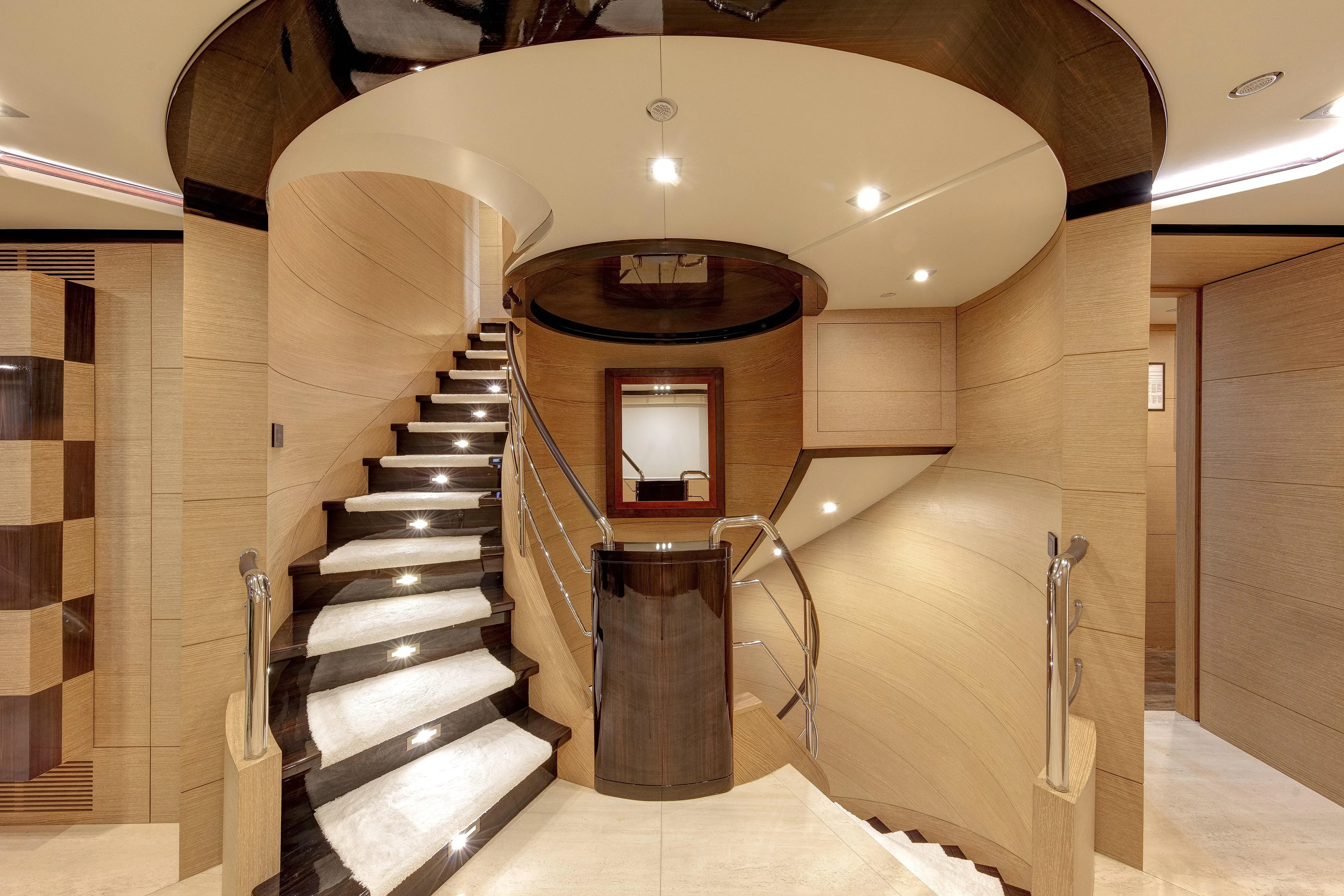 Sur La Mer Yacht Photos Pics Luxurious interior staircase of 2011 Benetti Vision 145 yacht, featuring elegant wood and modern design.