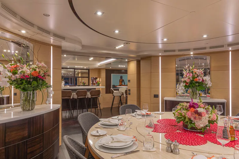 Sur La Mer Yacht Photos Pics Luxurious dining area on 2011 Benetti Vision 145 yacht, featuring elegant decor and floral arrangements.