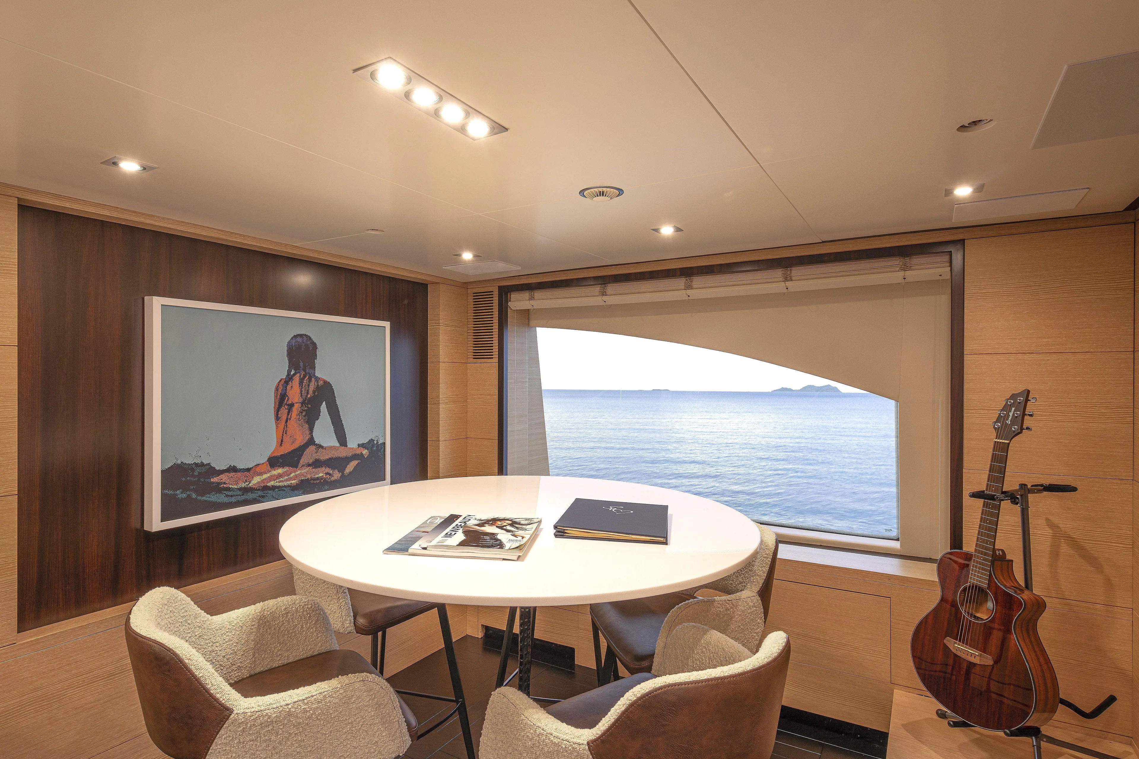 Sur La Mer Yacht Photos Pics Luxurious Benetti Vision 145 yacht interior with ocean view, round table, and guitar, 2011 model.