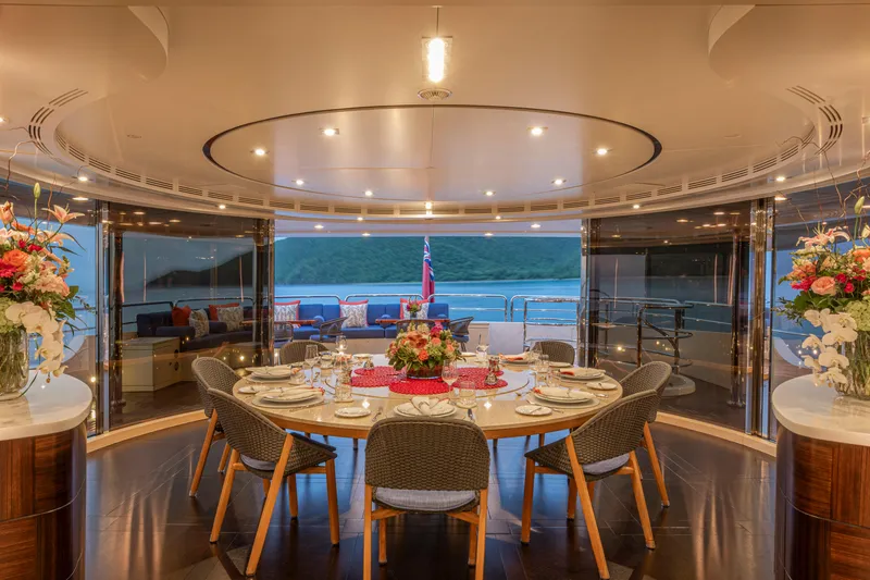 Sur La Mer Yacht Photos Pics Luxurious dining area on 2011 Benetti Vision 145 yacht, elegantly set with floral arrangements.
