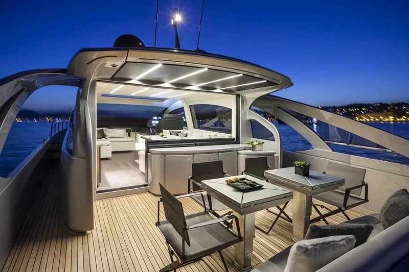  Yacht Photos Pics Luxurious 2018 Pershing 7X yacht interior at sunset, featuring elegant dining and seating areas.