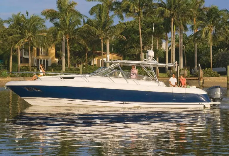 Relentless Yacht Photos Pics Manufacturer Provided Image: 2014 Intrepid 430 Sport Yacht cruising on a calm waterway with palm trees in the background.