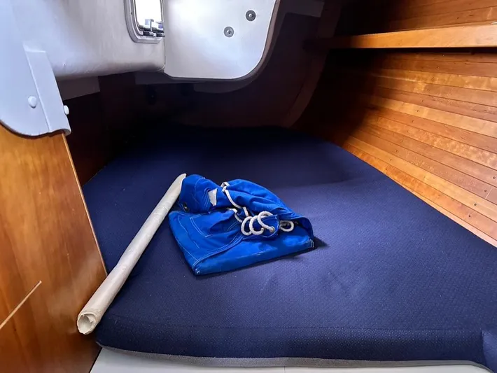 "legacy" Yacht Photos Pics Interior cabin of 2006 J Boats J/109 with blue cushion and rolled sail.