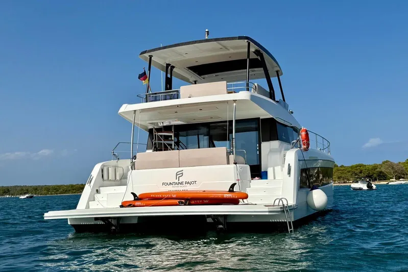  Yacht Photos Pics 2025 Fountaine Pajot MY6 yacht on water, rear view, sunny day.