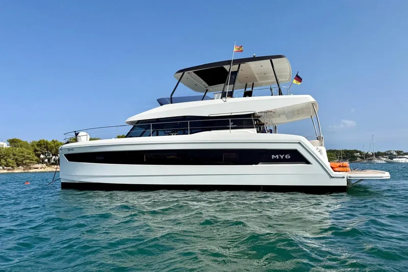  Yacht Photos Pics 2025 Fountaine Pajot MY6 yacht on serene blue waters, showcasing sleek design and luxury.