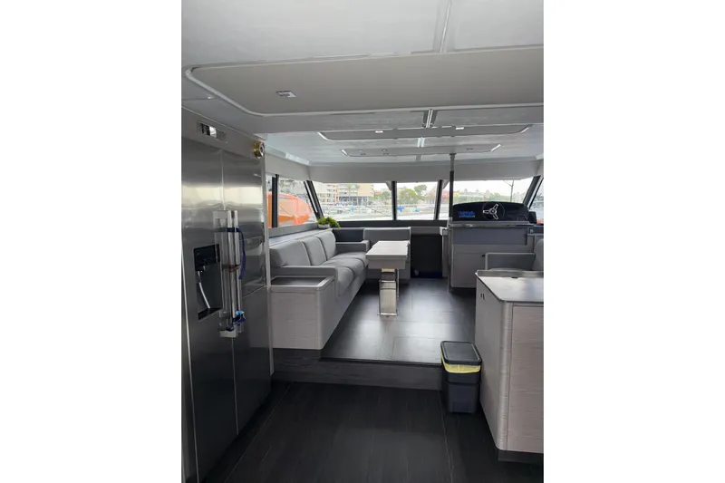  Yacht Photos Pics Luxurious interior of 2025 Fountaine Pajot MY6 yacht with modern furnishings and panoramic windows.