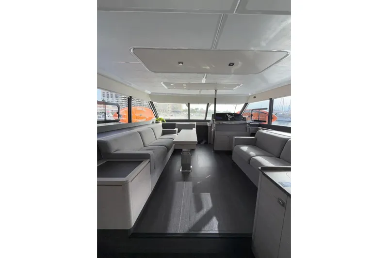  Yacht Photos Pics Luxurious interior of 2025 Fountaine Pajot MY6 yacht with modern seating and panoramic windows.