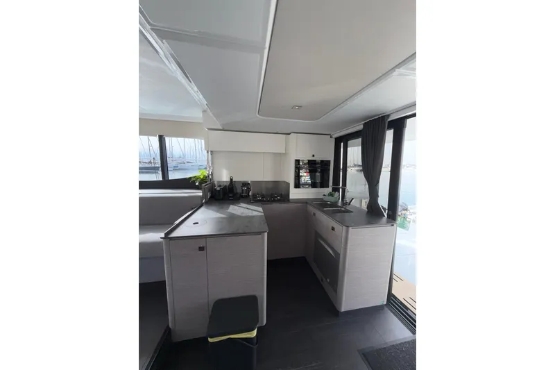  Yacht Photos Pics Modern kitchen interior of 2025 Fountaine Pajot MY6 yacht with sleek design and large windows.