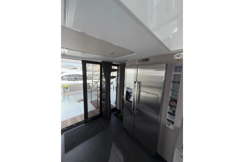 Yacht Photos Pics Interior of 2025 Fountaine Pajot MY6 yacht with modern kitchen and outdoor view.