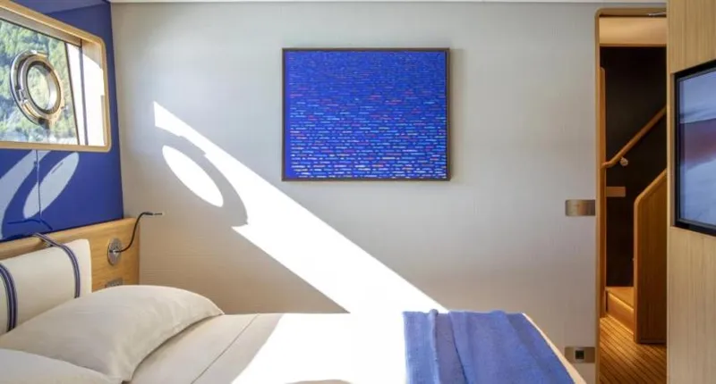  Yacht Photos Pics Luxurious bedroom interior on 2023 Custom Line Navetta 30 yacht, featuring modern decor and natural light.