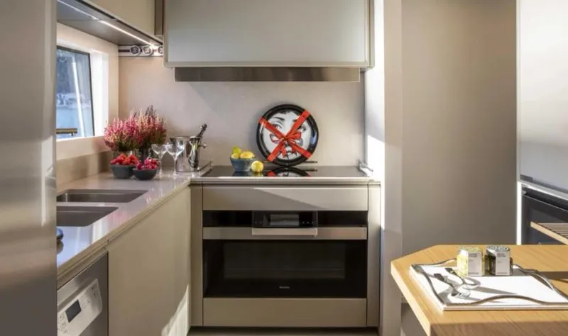  Yacht Photos Pics Modern kitchen interior on 2023 Custom Line Navetta 30 yacht, featuring sleek appliances and decor.