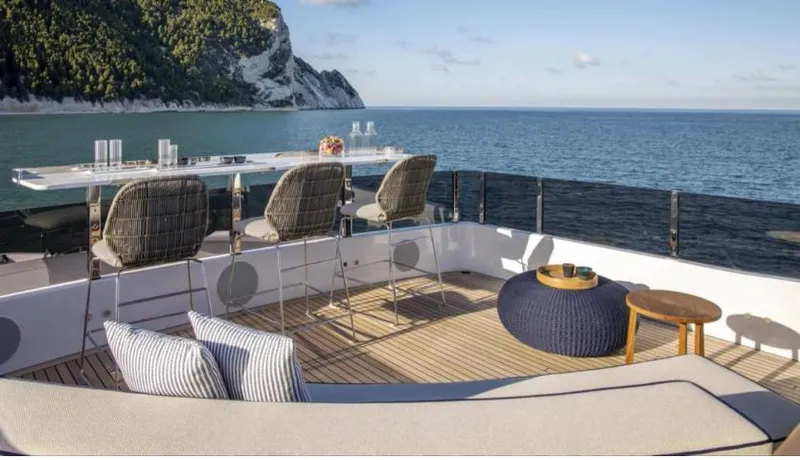  Yacht Photos Pics Luxurious 2023 Custom Line Navetta 30 yacht deck with ocean view and elegant seating.