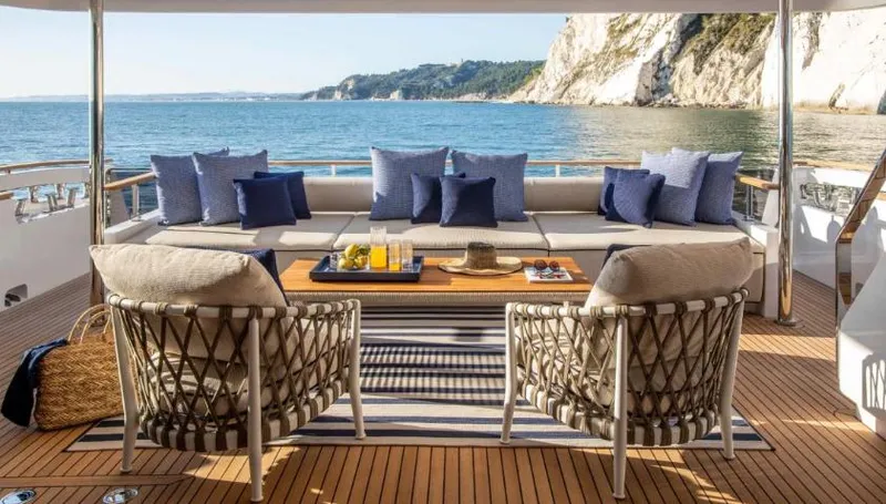  Yacht Photos Pics Luxurious 2023 Custom Line Navetta 30 yacht deck with elegant seating, ocean view, and stylish decor.
