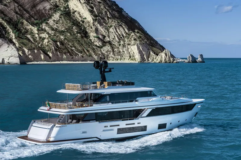  Yacht Photos Pics Luxury yacht Custom Line Navetta 30 cruising near rocky coastline, 2023 model.