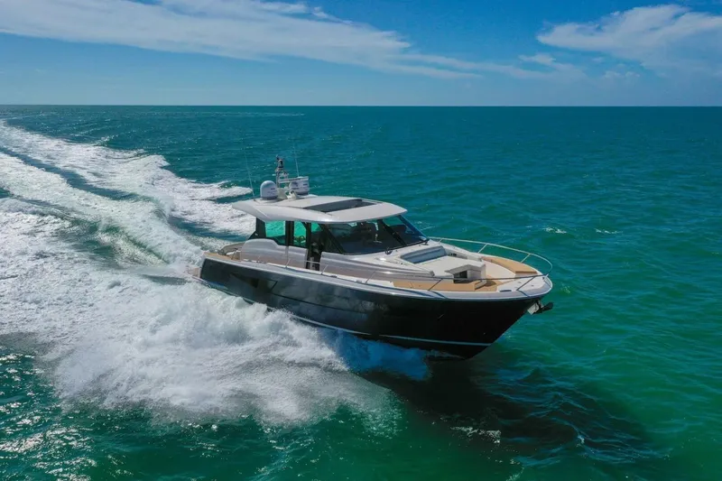 Tranquil Moments II Yacht Photos Pics 2023 Tiara Yachts EX 60 cruising on open ocean under clear blue sky.