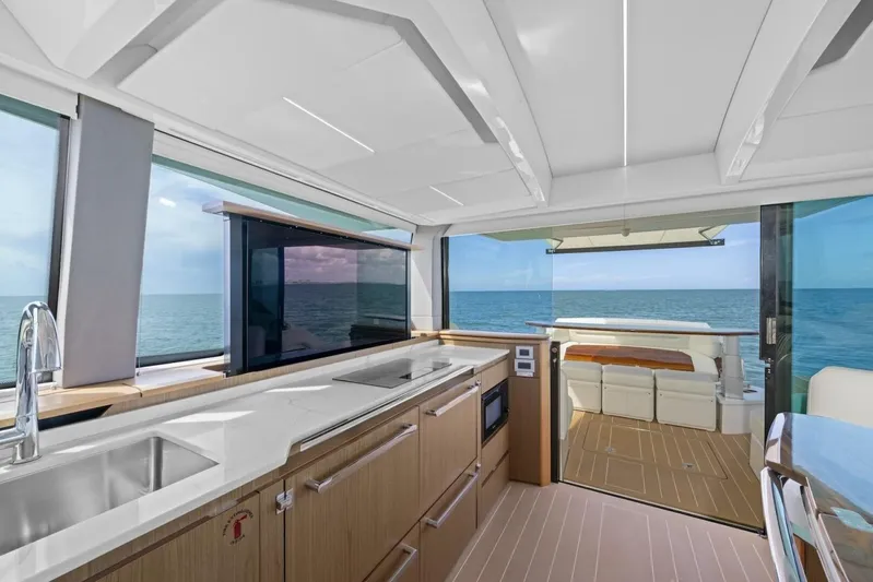 Tranquil Moments II Yacht Photos Pics Luxurious interior of 2023 Tiara Yachts EX 60 with ocean view and modern amenities.