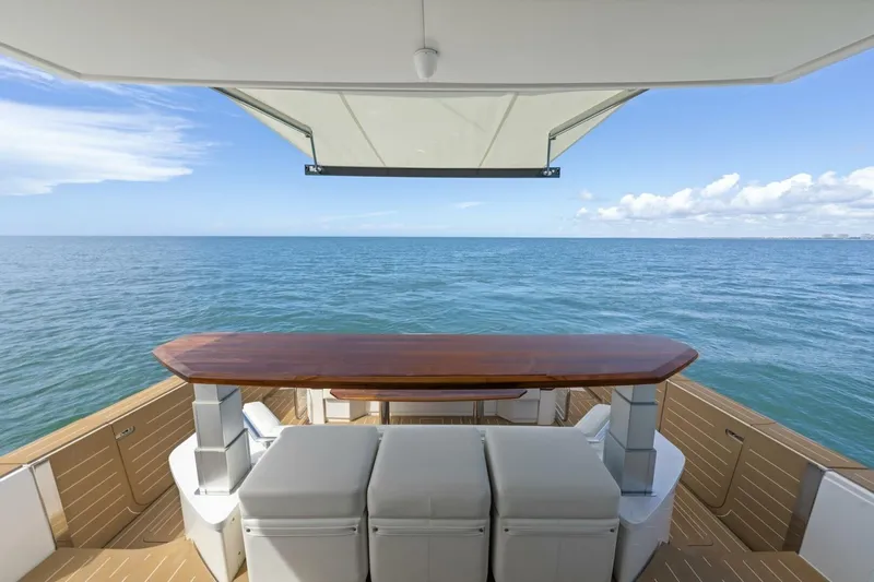 Tranquil Moments II Yacht Photos Pics Luxurious 2023 Tiara Yachts EX 60 deck with ocean view and elegant seating area.