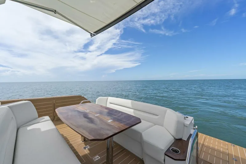 Tranquil Moments II Yacht Photos Pics Luxurious 2023 Tiara Yachts EX 60 deck with ocean view and elegant seating area.