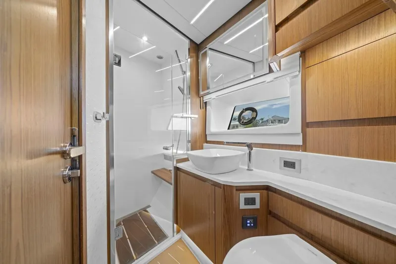 Tranquil Moments II Yacht Photos Pics Luxurious bathroom in 2023 Tiara Yachts EX 60, featuring modern fixtures and elegant wood finishes.