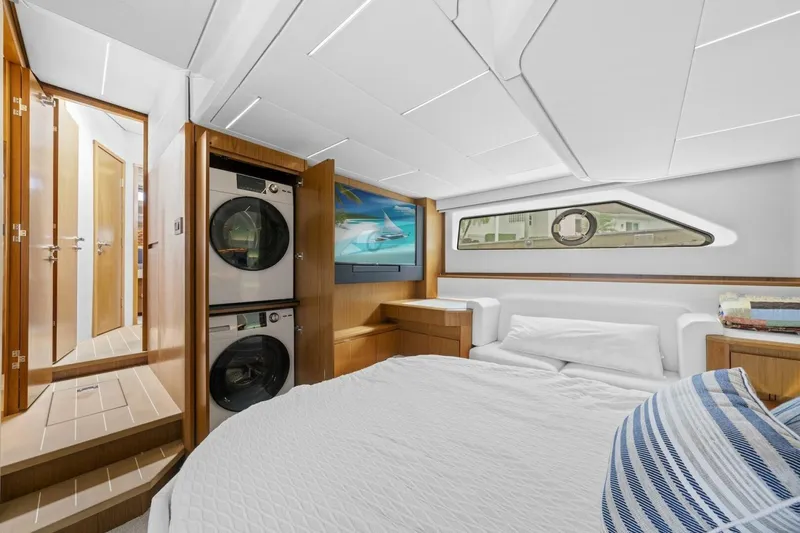 Tranquil Moments II Yacht Photos Pics 2023 Tiara Yachts EX 60 interior with bed, washer-dryer, and porthole window.