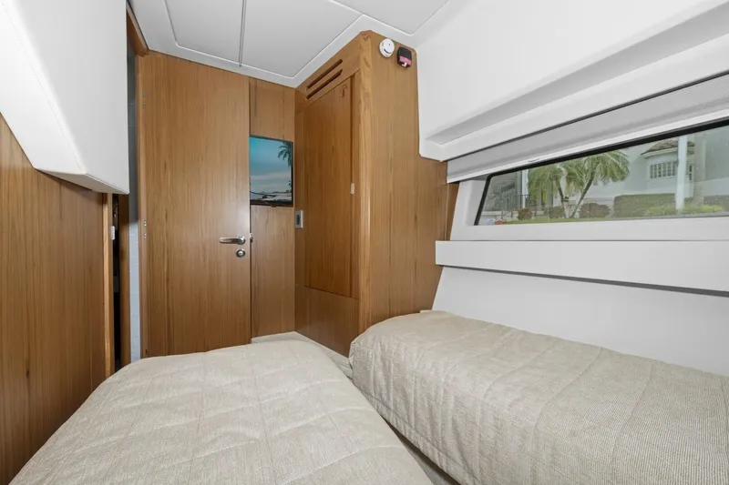 Tranquil Moments II Yacht Photos Pics 2023 Tiara Yachts EX 60 cabin with twin beds and wooden interior design.