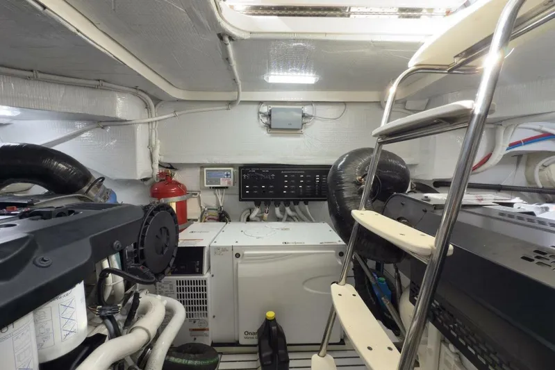 Tranquil Moments II Yacht Photos Pics Engine room of 2023 Tiara Yachts EX 60, featuring equipment and ladder access.