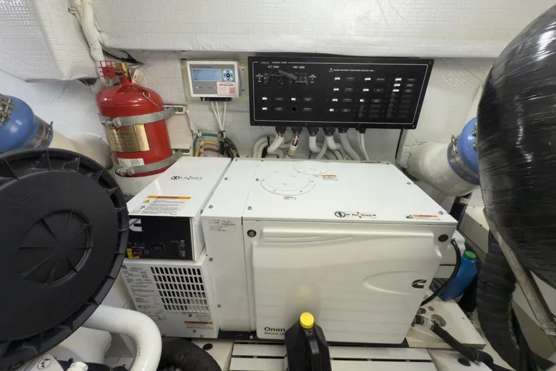 Tranquil Moments II Yacht Photos Pics Engine room of 2023 Tiara Yachts EX 60 with generator and control panel.