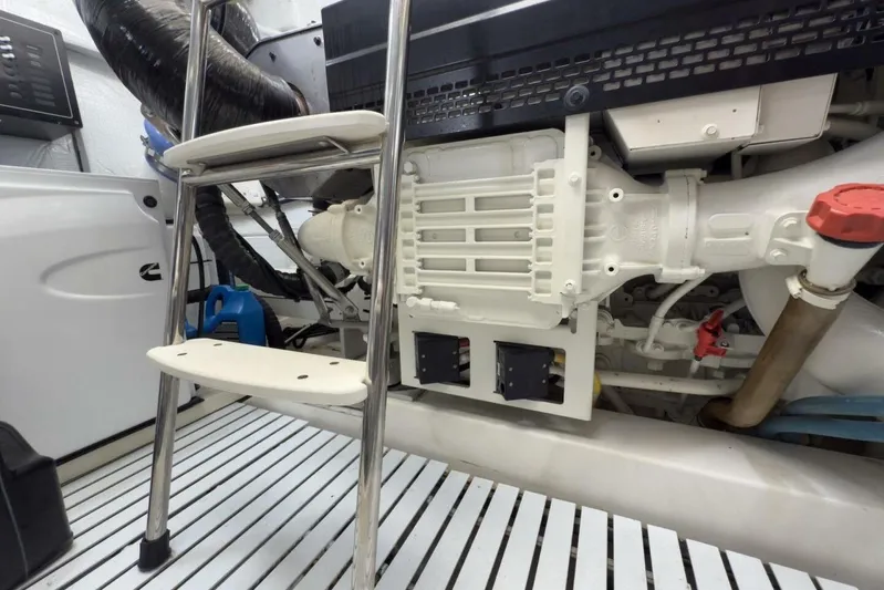 Tranquil Moments II Yacht Photos Pics Engine room of 2023 Tiara Yachts EX 60, featuring mechanical components and ladder.