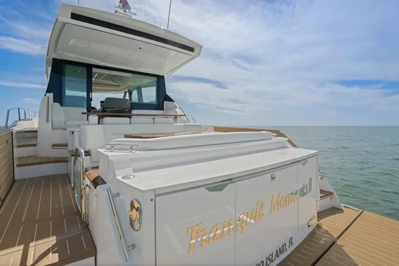 Tranquil Moments II Yacht Photos Pics 2023 Tiara Yachts EX 60 luxury yacht on open water, showcasing sleek design and spacious deck.