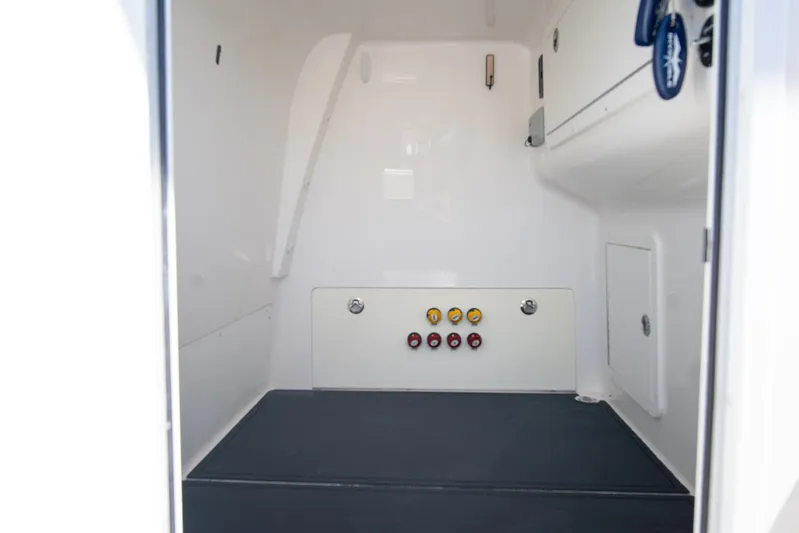  Yacht Photos Pics Interior view of 2019 Invincible 37 Catamaran, featuring control panel and storage compartments.