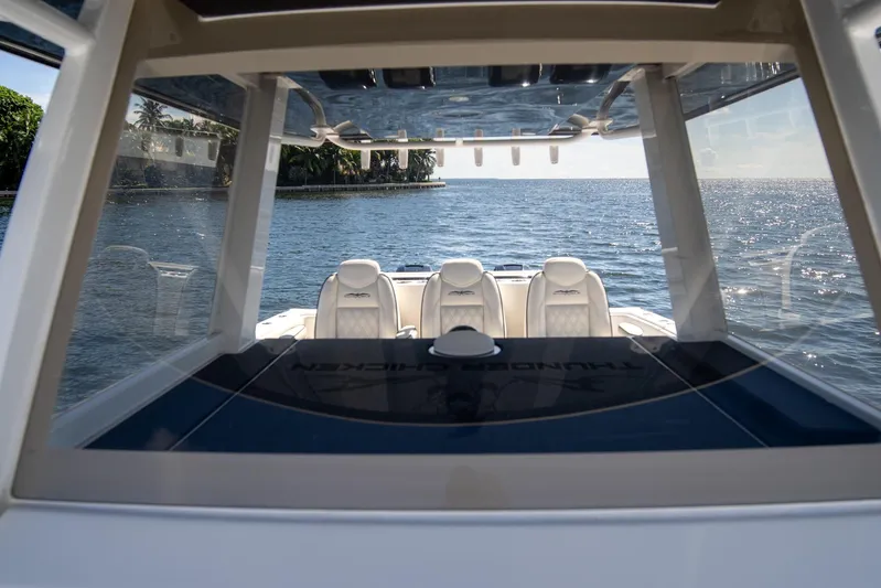  Yacht Photos Pics 2019 Invincible 37 Catamaran on serene water, showcasing luxurious seating and sleek design.