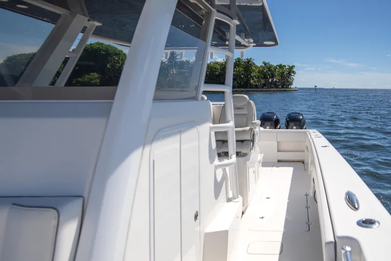  Yacht Photos Pics 2019 Invincible 37 Catamaran on calm waters, showcasing sleek design and spacious deck.