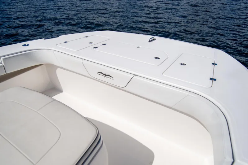  Yacht Photos Pics 2019 Invincible 37 Catamaran deck with storage compartments, on calm water.