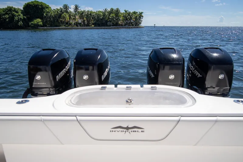  Yacht Photos Pics 2019 Invincible 37 Catamaran with four Mercury engines on a serene ocean backdrop.
