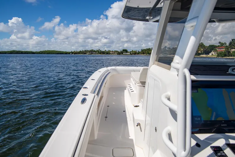 Yacht Photos Pics 2019 Invincible 37 Catamaran cruising on open water under a clear blue sky.