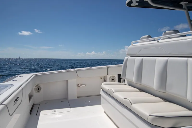  Yacht Photos Pics 2019 Invincible 37 Catamaran interior with ocean view, featuring comfortable seating and clear skies.