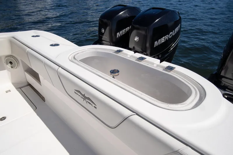  Yacht Photos Pics 2019 Invincible 37 Catamaran with Mercury engines, featuring a sleek white deck and storage compartment.