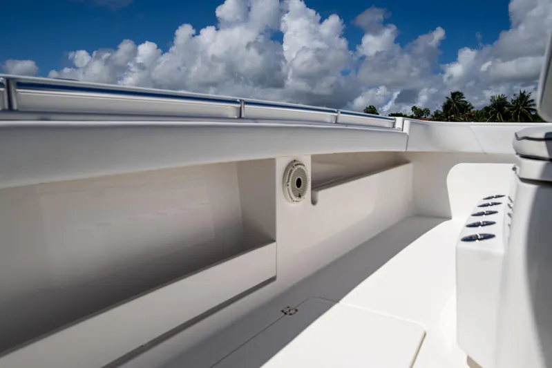  Yacht Photos Pics 2019 Invincible 37 Catamaran deck with storage and speaker, under a cloudy sky.