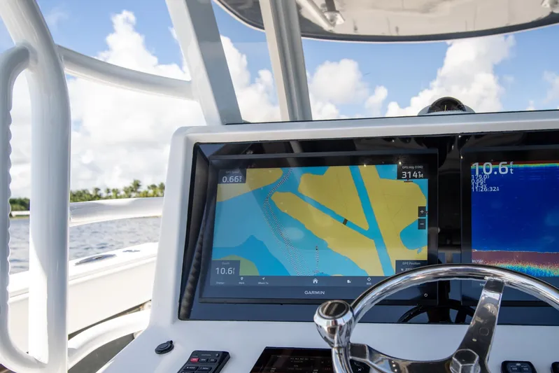  Yacht Photos Pics 2019 Invincible 37 Catamaran dashboard with Garmin navigation display and steering wheel.