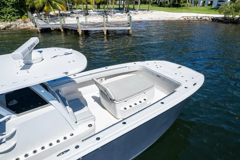  Yacht Photos Pics 2019 Invincible 37 Catamaran docked by tropical beach with palm trees.