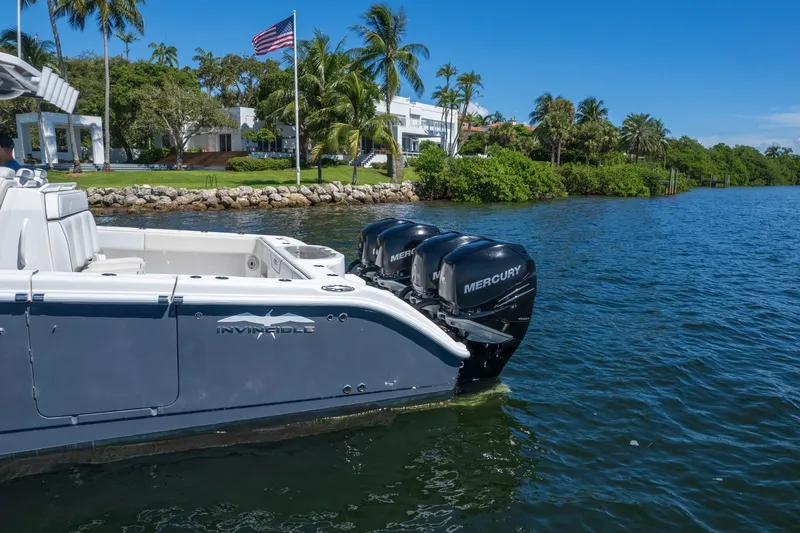  Yacht Photos Pics 2019 Invincible 37 Catamaran with Mercury engines on a scenic waterfront.