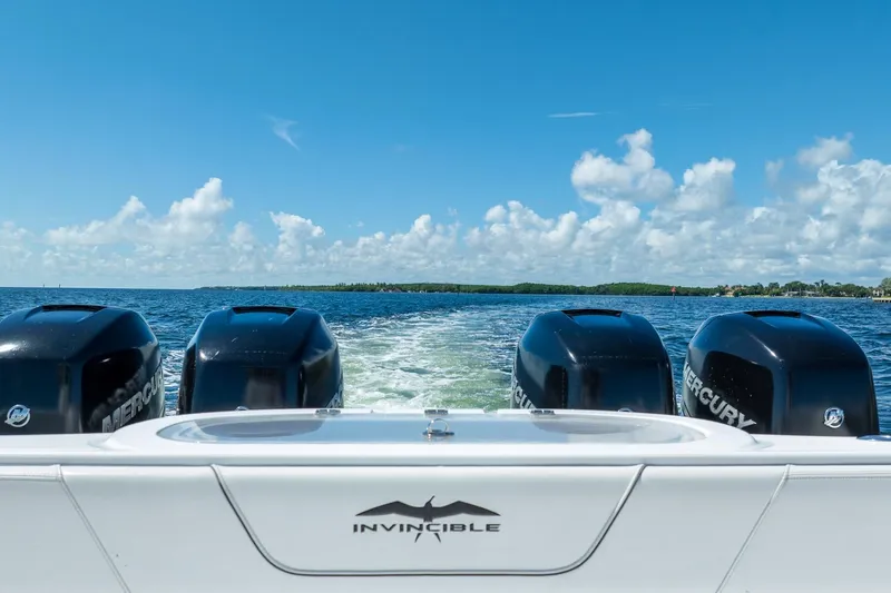  Yacht Photos Pics 2019 Invincible 37 Catamaran with four Mercury engines cruising on open water.