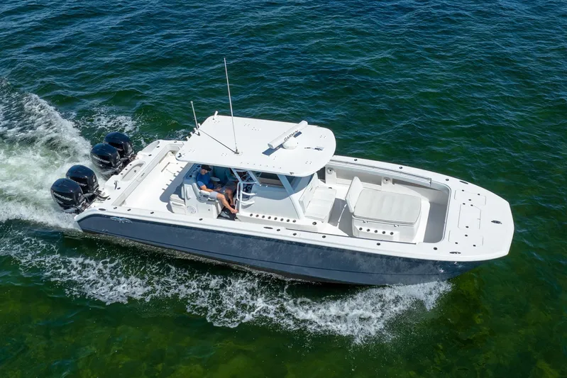  Yacht Photos Pics 2019 Invincible 37 Catamaran cruising on clear blue water, showcasing sleek design and powerful engines.