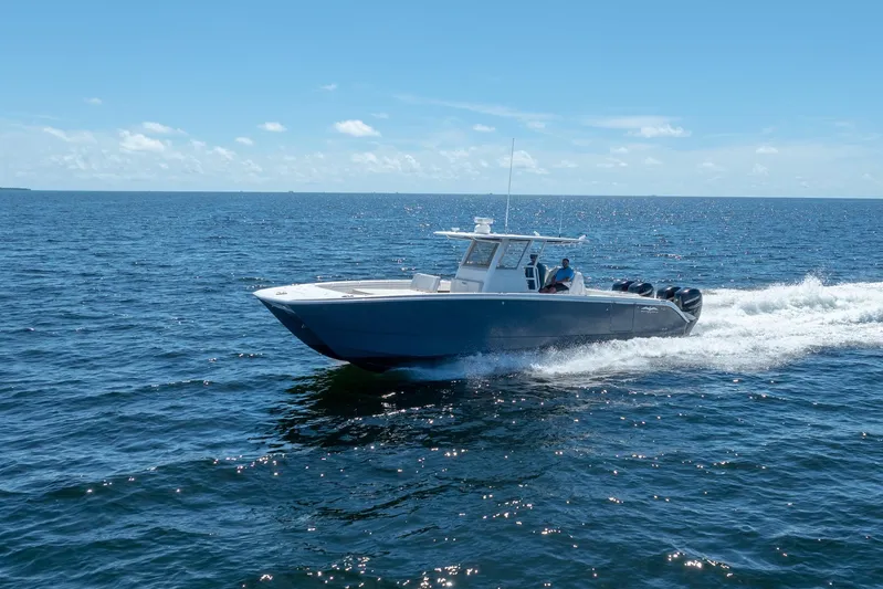  Yacht Photos Pics 2019 Invincible 37 Catamaran cruising on open ocean under clear blue sky.