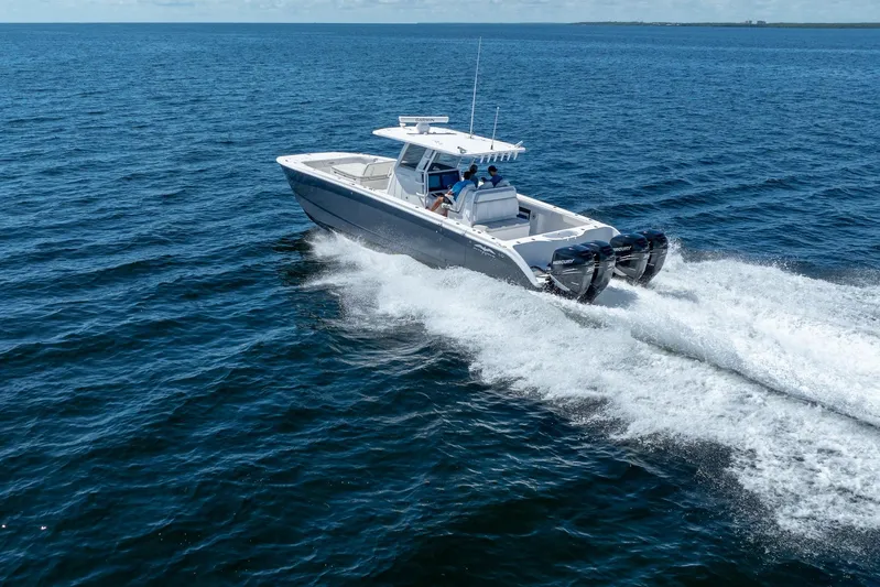  Yacht Photos Pics 2019 Invincible 37 Catamaran cruising on open water, showcasing powerful engines and sleek design.